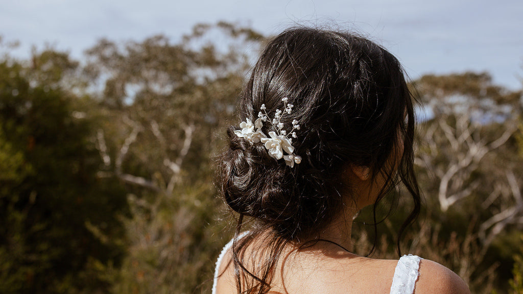 Woman with a floral hairpiece in an outdoor setting